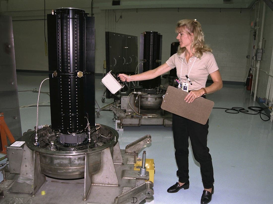 Radiation protection technician manually surveying nuclear equipment